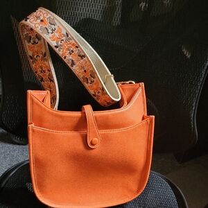 Vibrant Orange Shoulder Bag with Patterned Strap